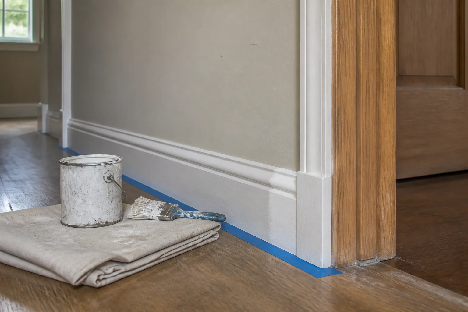 Freshly painted skirting and door trim in an ordinary hallway